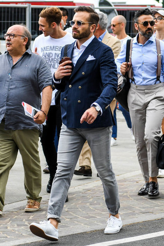 Navy Vertical Striped Blazer Outfits For Men: This is hard proof that a navy vertical striped blazer and grey jeans look amazing when worn together. Rev up your outfit by finishing with a pair of white leather low top sneakers.
