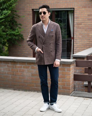 Dark Brown Double Breasted Blazer Outfits For Men: A dark brown double breasted blazer and navy jeans make for the perfect base for a ton of ensembles. Why not take a more relaxed approach with footwear and enter a pair of white canvas low top sneakers into the equation?