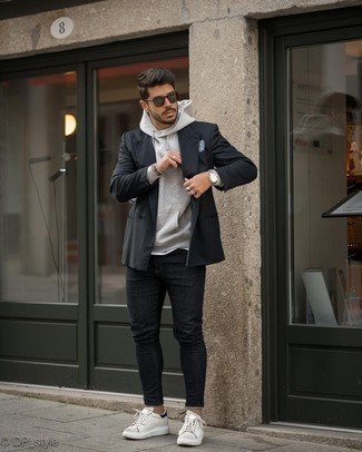 Charcoal Hoodie Outfits For Men: A charcoal hoodie and black skinny jeans are awesome menswear essentials to add to your daily casual lineup. And if you want to effortlessly lift up this ensemble with a pair of shoes, complement this getup with white and black leather low top sneakers.