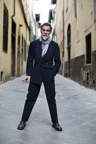 Simone Righi wearing Navy Double Breasted Blazer, Grey Long Sleeve Shirt, Navy Dress Pants, Dark Brown Leather Brogues
