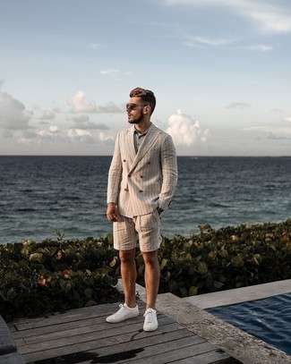 Beige Vertical Striped Blazer Outfits For Men: This pairing of a beige vertical striped blazer and beige vertical striped shorts will add powerful essence to your getup. Clueless about how to finish off? Complement your getup with a pair of white leather low top sneakers to shake things up.