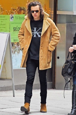 Harry Styles wearing Tan Suede Chelsea Boots, Black Wool Dress Pants, Black Print Crew-neck Sweater, Tan Shearling Coat