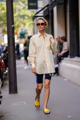 Bike Shorts Outfits: A yellow dress shirt and bike shorts are a great combination to keep in your daily styling arsenal. A pair of yellow rubber flat sandals will add a little edge to a femme classic ensemble.