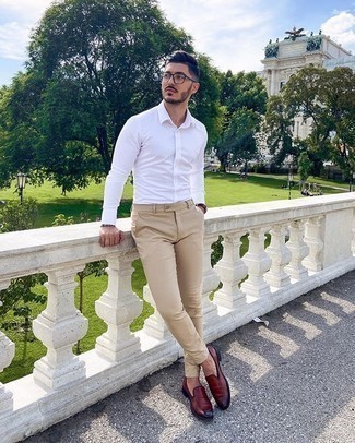 Burgundy Leather Loafers Outfits For Men: This is definitive proof that a white dress shirt and beige chinos are awesome when matched together. On the fence about how to finish off your look? Finish off with a pair of burgundy leather loafers to dress it up.