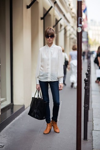 Beige Leather Ankle Boots Outfits: Reach for a white silk dress shirt and navy skinny jeans to feel confident and look incredibly stylish. We're loving how complete this outfit looks when rounded off with beige leather ankle boots.