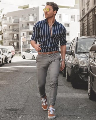 Men's Navy and White Vertical Striped Dress Shirt, Grey Skinny Jeans, Tobacco Suede Low Top Sneakers, Tan Leather Belt
