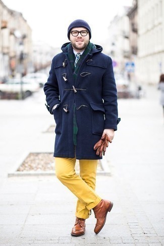 1200+ Dressy Cold Weather Outfits For Men: Putting together a navy duffle coat with mustard dress pants is a wonderful pick for a classic and elegant look. Complement this outfit with brown leather brogue boots to make the ensemble more fun.