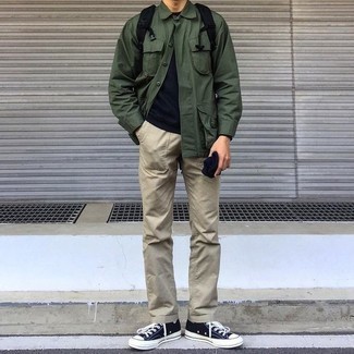 Black Canvas Backpack Outfits For Men: Consider teaming a dark green field jacket with a black canvas backpack if you wish to look casually cool without too much work. With footwear, go for something on the dressier end of the spectrum and complement your look with black and white canvas low top sneakers.