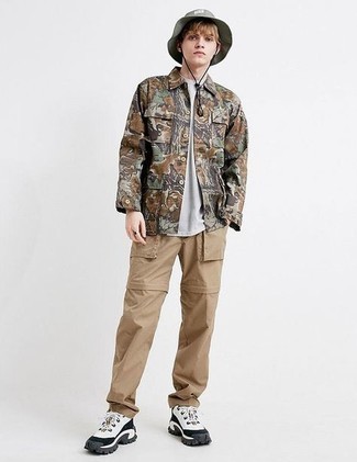 Grey Bucket Hat Outfits For Men: If you put function above all, this casual street style combination of a brown camouflage field jacket and a grey bucket hat is your go-to. Clueless about how to round off this ensemble? Round off with a pair of white and black athletic shoes to bump up the style factor.