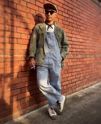 Overalls Outfits For Men: An olive field jacket and overalls make for the ultimate casual look for any gentleman. White canvas low top sneakers are a stylish accompaniment for this ensemble.