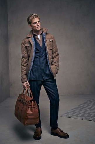 Duffle Bag Outfits For Men: This pairing of a brown field jacket and a duffle bag gives off this so-chill and effortless kind of vibe. Introduce a pair of dark brown leather double monks to the equation to make the outfit slightly smarter.