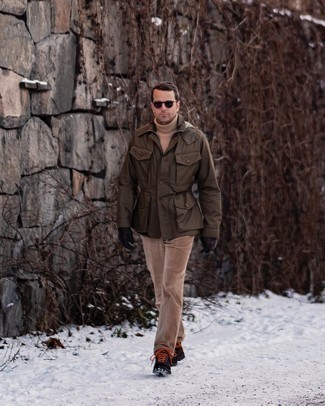 Work Boots Outfits For Men: Dress in a dark brown field jacket and khaki corduroy chinos for a hassle-free look that's also put together. For shoes, go down a more casual route with work boots.