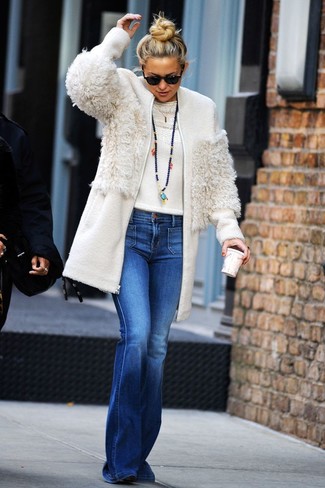 Kate Hudson wearing Black Suede Ankle Boots, Blue Flare Jeans, White Crew-neck Sweater, White Fleece Coat