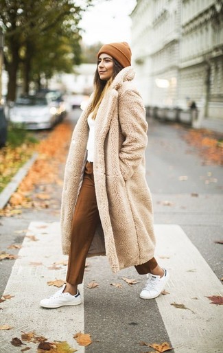 Beige Fur Coat Outfits: Irrefutable proof that a beige fur coat and tobacco dress pants are awesome when paired together in a polished look. For a more relaxed spin, why not add white leather low top sneakers to your getup?