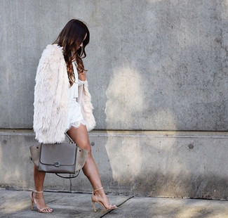 White Lace Shorts Chill Weather Outfits For Women: Pairing a white fur coat with white lace shorts is a good option for a totaly chic and polished outfit. Let your sartorial credentials truly shine by rounding off your outfit with tan leather heeled sandals.