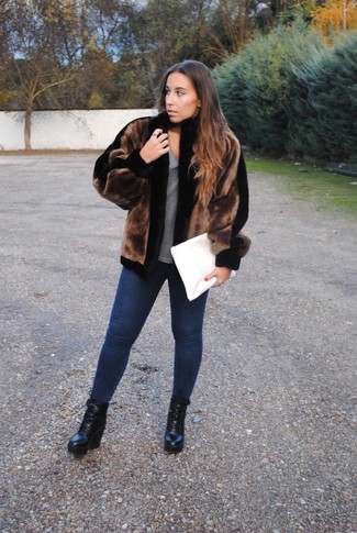 Navy Skinny Jeans Outfits: For a cool and casual look, try pairing a dark brown fur jacket with navy skinny jeans — these items play perfectly well together. The whole ensemble comes together when you complement your ensemble with black leather lace-up ankle boots.