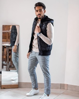 White Leather Low Top Sneakers Outfits For Men: This off-duty combination of a black quilted gilet and grey plaid chinos is extremely easy to put together without a second thought, helping you look amazing and prepared for anything without spending a ton of time rummaging through your wardrobe. Now all you need is a pair of white leather low top sneakers to round off your look.