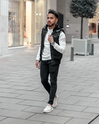 Men's Black Quilted Gilet, White Crew-neck Sweater, Black Skinny Jeans, White and Navy Canvas Low Top Sneakers