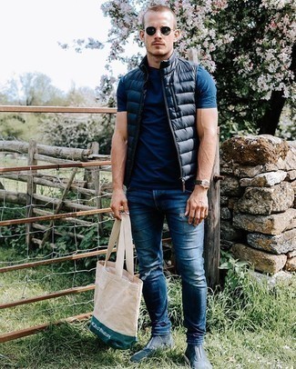 Beige Print Canvas Tote Bag Outfits For Men: A navy quilted gilet and a beige print canvas tote bag are a casual combo that every modern guy should have in his menswear collection. Why not complete this look with a pair of navy suede chelsea boots for an extra dose of polish?
