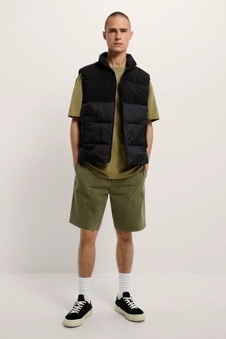 Black and White Canvas Low Top Sneakers Outfits For Men: This casual combination of a black quilted gilet and olive shorts is ideal when you want to go about your day with confidence in your look. The whole getup comes together when you introduce black and white canvas low top sneakers to the equation.