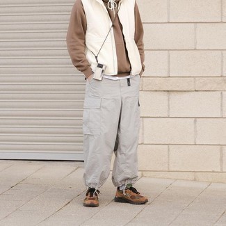Brown Athletic Shoes Outfits For Men: Go for a simple but casually dapper option by wearing a white gilet and grey cargo pants. Introduce a pair of brown athletic shoes to this ensemble to easily step up the street cred of this look.