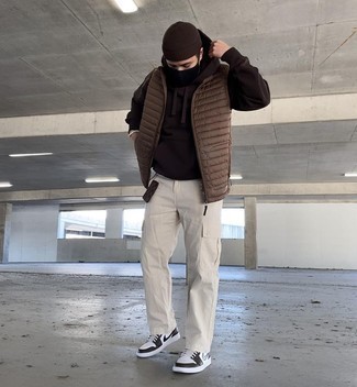 Brown Gilet Outfits For Men: Why not try teaming a brown gilet with beige cargo pants? As well as super comfortable, these two items look awesome together. Our favorite of a multitude of ways to complement this look is with a pair of white and black leather low top sneakers.