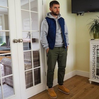 Navy Quilted Gilet Outfits For Men: If you're seeking to take your casual style game to a new height, wear a navy quilted gilet with olive chinos. To add a little depth to your look, introduce tan suede derby shoes to this outfit.