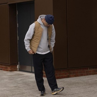 Navy Beanie Outfits For Men: For an off-duty getup with an edgy spin, wear a tan quilted gilet with a navy beanie. Let your outfit coordination skills really shine by completing this ensemble with black and white athletic shoes.