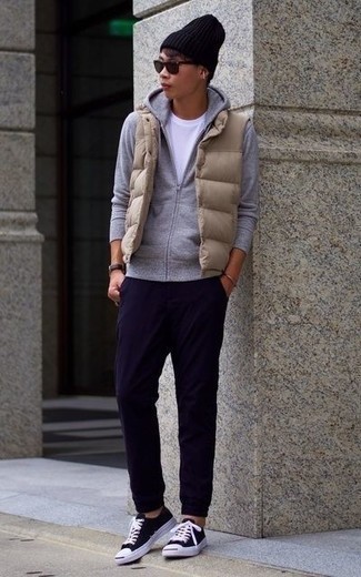 Tan Quilted Gilet Outfits For Men: Consider teaming a tan quilted gilet with navy chinos to demonstrate your styling smarts. Black and white canvas low top sneakers look great here.