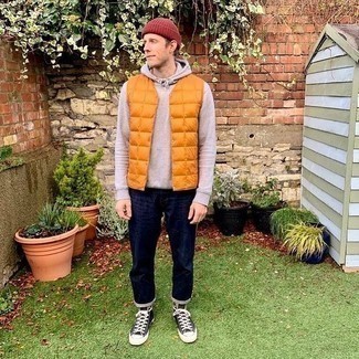 Gilet Outfits For Men: If you don't like being too serious with your combinations, pair a gilet with navy jeans. Complement your outfit with black and white canvas high top sneakers to have some fun with things.