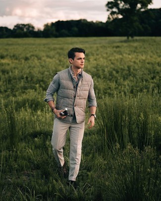 Grey Quilted Wool Gilet Outfits For Men: This combo of a grey quilted wool gilet and grey chinos is the perfect balance between comfortable and dapper. Balance out this ensemble with a more refined kind of shoes, such as this pair of dark brown leather casual boots.