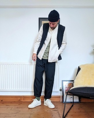 White Leather Low Top Sneakers Outfits For Men: This combo of a navy gilet and navy chinos combines comfort and casual cool. With shoes, stick to a more casual route with a pair of white leather low top sneakers.