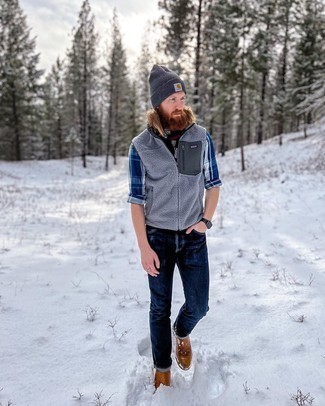 Grey Fleece Gilet Outfits For Men: This combo of a grey fleece gilet and navy jeans is a safe and very stylish bet. Complete your ensemble with brown leather chelsea boots to change things up a bit.