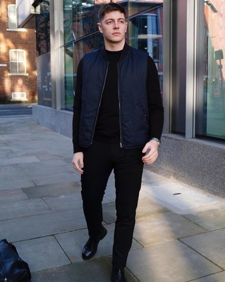 Duffle Bag Outfits For Men: If you enjoy a more casual approach to menswear, why not make a navy gilet and a duffle bag your outfit choice? If you want to easily amp up this ensemble with footwear, complete your ensemble with black leather chelsea boots.