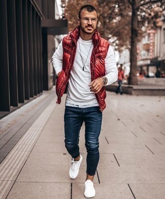 Red Quilted Gilet Casual Outfits For Men: If you're on a mission for a relaxed casual but also seriously stylish outfit, try pairing a red quilted gilet with navy skinny jeans. On the fence about how to finish your outfit? Rock a pair of white canvas low top sneakers to amp it up a notch.