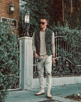 Dark Green Gilet Outfits For Men: Make a dark green gilet and white ripped jeans your outfit choice to get an urban and absolutely dapper ensemble. If in doubt about the footwear, complete this ensemble with a pair of white star print canvas high top sneakers.