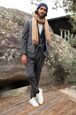 Tan Scarf Outfits For Men: Wear a charcoal quilted wool gilet and a tan scarf to achieve a laid-back and comfortable look. A trendy pair of white leather low top sneakers is the simplest way to give an extra touch of elegance to your outfit.