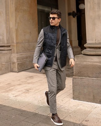 Blue Quilted Gilet Outfits For Men: A blue quilted gilet and a grey suit are a seriously sharp ensemble to try. Add a pair of dark brown leather low top sneakers to the equation to make a traditional look feel suddenly edgier.