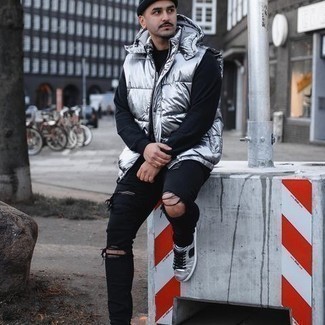 Grey Leather Low Top Sneakers Outfits For Men: If you like comfortable ensembles, reach for a silver gilet and black ripped skinny jeans. Complement your outfit with a pair of grey leather low top sneakers for a hint of polish.