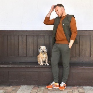 Dark Brown Sweatshirt Outfits For Men: If you're looking for a city casual yet dapper look, reach for a dark brown sweatshirt and olive sweatpants. Complete this getup with a pair of orange athletic shoes to have some fun with things.