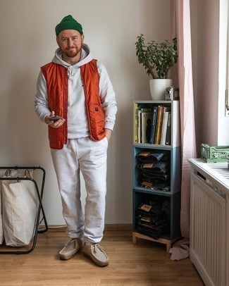 Track Suit Outfits For Men: This laid-back pairing of a track suit and an orange quilted gilet is super versatile and really apt for whatever adventure you may find yourself on. If you need to instantly rev up your getup with a pair of shoes, why not add beige canvas desert boots to the mix?
