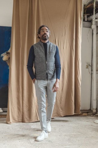 Grey Quilted Wool Gilet Outfits For Men: Consider wearing a grey quilted wool gilet and grey chinos to achieve a casually cool outfit. White canvas low top sneakers are a good option to round off this ensemble.