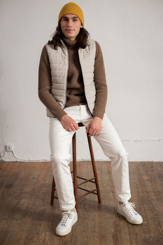 Tan Quilted Gilet Outfits For Men: This casual combo of a tan quilted gilet and white jeans is super easy to put together in no time, helping you look dapper and prepared for anything without spending a ton of time combing through your wardrobe. Complement this outfit with white leather low top sneakers for extra fashion points.