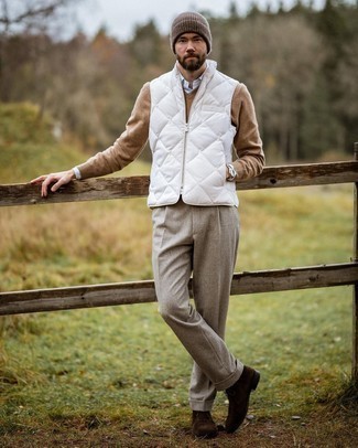 White Quilted Gilet Outfits For Men: This ensemble suggests it pays to invest in such smart menswear pieces as a white quilted gilet and beige dress pants. You could perhaps get a bit experimental in the footwear department and add a pair of dark brown suede desert boots to this getup.