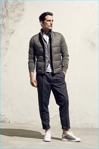 Olive Gilet Outfits For Men: As you can see here, looking sharp doesn't require that much effort. Just pair an olive gilet with charcoal vertical striped dress pants and be sure you'll look awesome. For times when this ensemble appears all-too-polished, dial it down by wearing a pair of white low top sneakers.