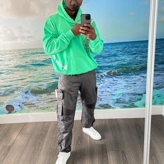 Grey Cargo Pants Outfits: Dress in a green print hoodie and grey cargo pants for a contemporary and stylish look. Why not enter white canvas low top sneakers into the equation for a sense of refinement?