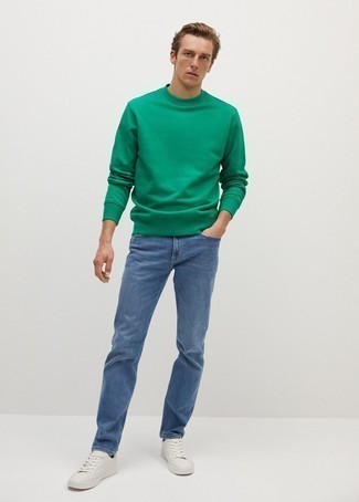 Green Sweatshirt Outfits For Men: Consider teaming a green sweatshirt with blue jeans for both sharp and easy-to-create ensemble. Complement your outfit with white leather low top sneakers for maximum style.