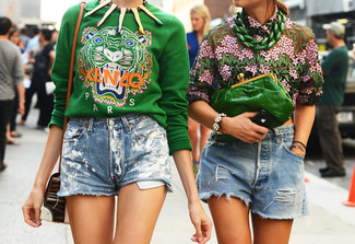Green Print Sweatshirt Outfits For Women: For a casual look, wear a green print sweatshirt with light blue denim shorts — these pieces go really well together.