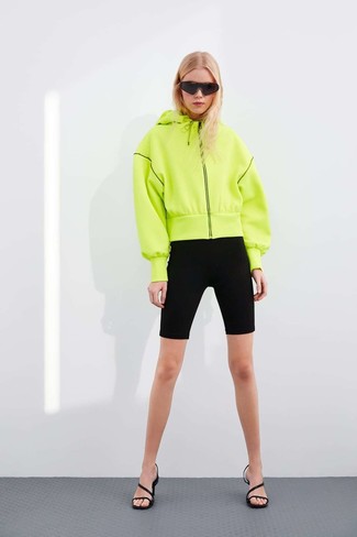 Green-Yellow Hoodie Outfits For Women: A green-yellow hoodie looks so nice when worn with black bike shorts in a casual ensemble. Go the extra mile and jazz up your look by wearing black leather heeled sandals.