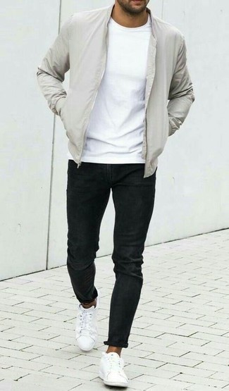Grey Bomber Jacket Outfits For Men: A grey bomber jacket and black jeans teamed together are a match made in heaven for gents who love neat and relaxed styles. White canvas low top sneakers are a nice choice to finish off this ensemble.